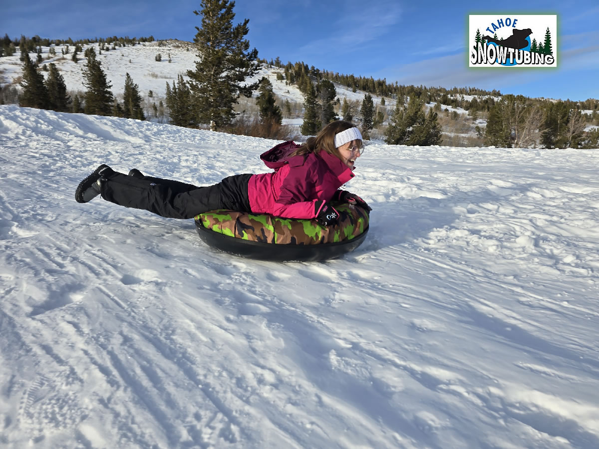 Person Tahoe Snow Tubing down snowy slope